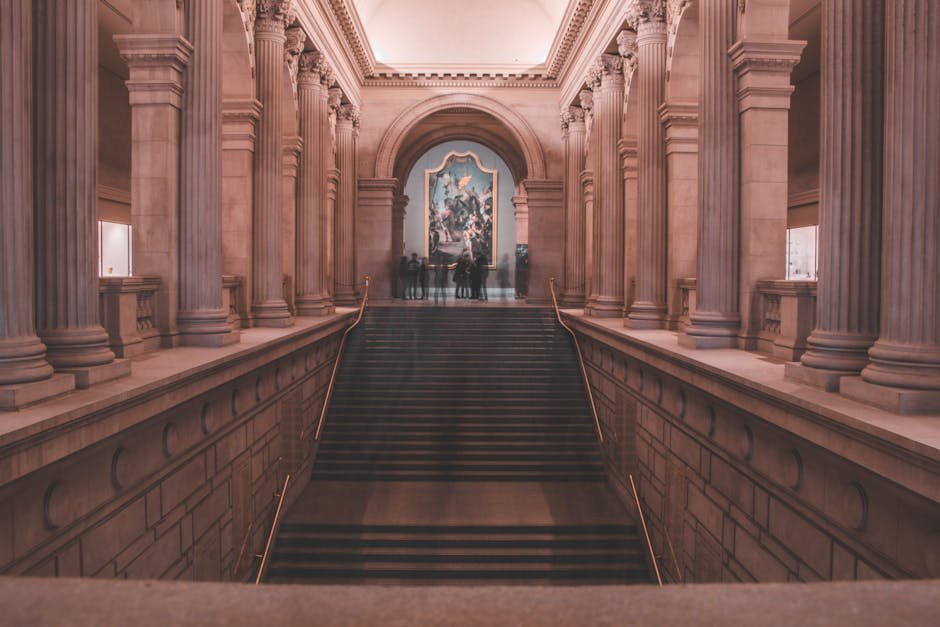A grand staircase with elegant columns inside a renowned art museum in New York City.