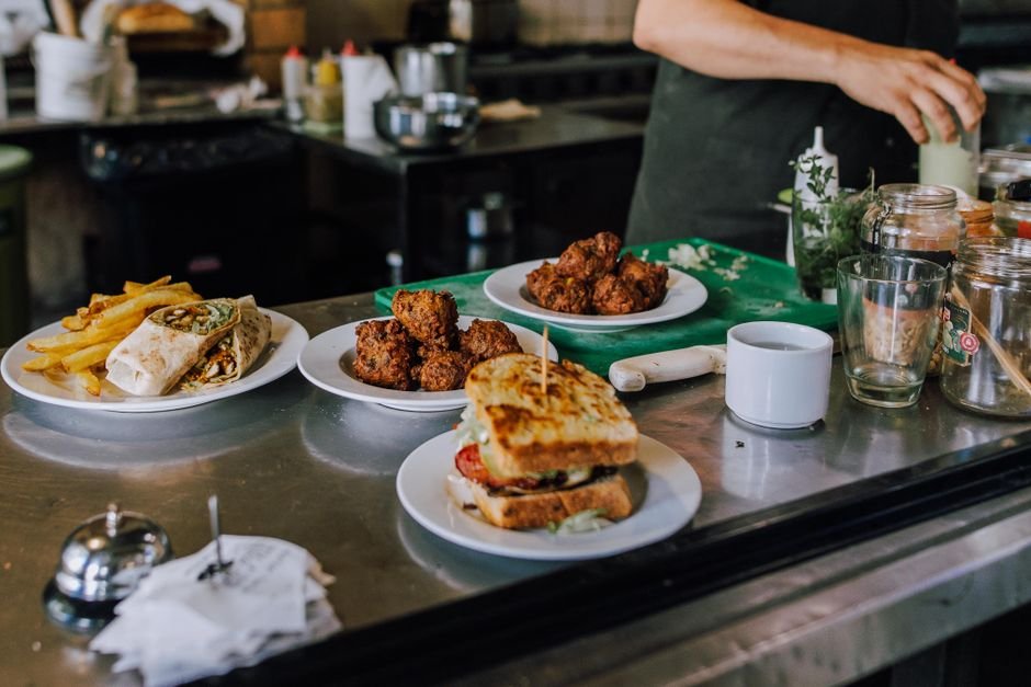 Gourmet selection of sandwiches, wraps, and fries in a Buenos Aires restaurant kitchen.