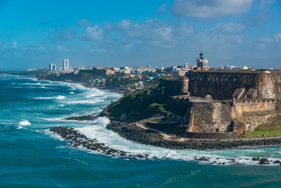 Scenic view of El Morro fortress and vibrant San Juan coastline, Puerto Rico.